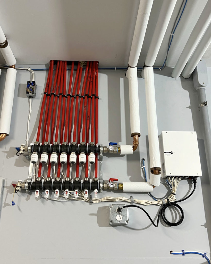 Hydronic manifold to provide heating and cooling. Messana mZone used to control hydronic distribution.