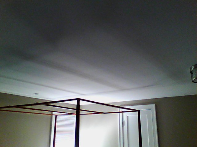 Ceiling with radiant cooling panels embedded behind the drywall.
