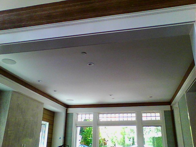 Ceiling with radiant cooling panels embedded behind the drywall.