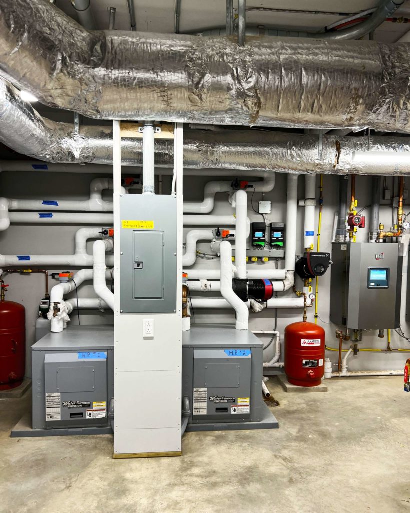 Two geothermal heat pumps used for hydronic heating and cooling using Ray Magic NK radiant ceiling panels and Jaga hydronic fan coils.