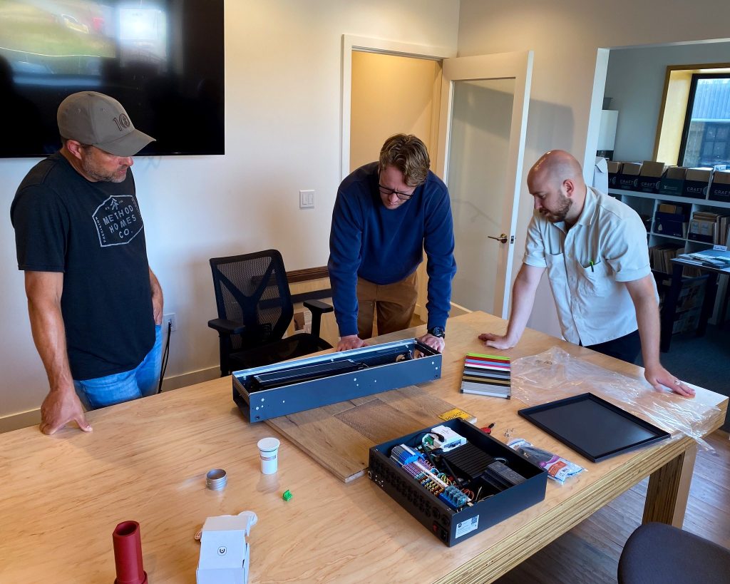 Modern Homes learning about modern hydronic solutions such as Messana mBox Hydronic Controllers, Jaga fan coil units, and Messana Ray Magic® radiant ceilings/floors.