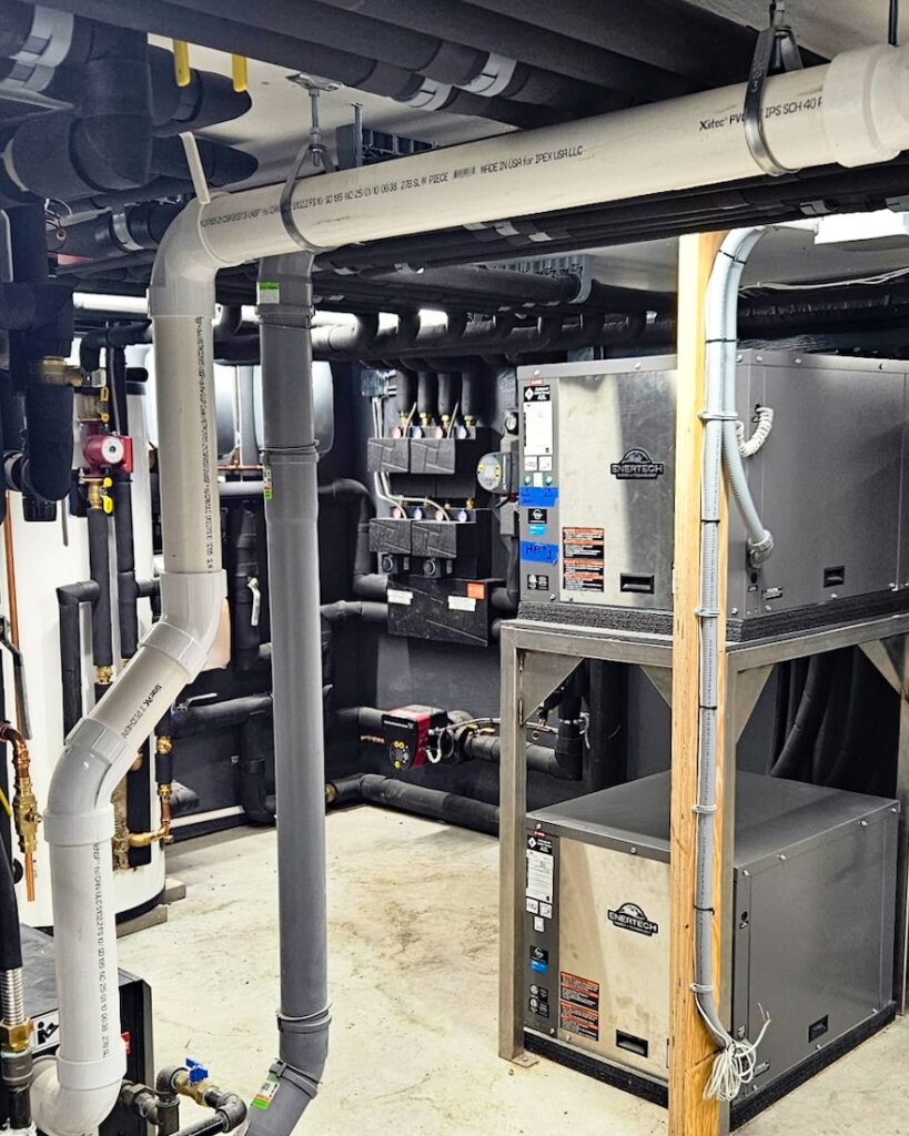 Geothermal heat pumps for a hybrid hydronic system that utilizes a radiant floor, radiant ceiling, and Jaga fan coil units.
