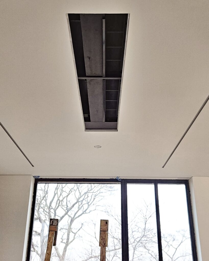 Jaga Astrabeam hydronic fan coil unit installed in the ceiling for hydronic heating and hydronic cooling.