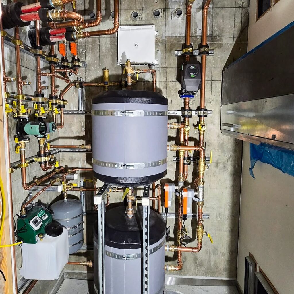 Mechanical room for Palo Alto hydronic system that provides heating and cooling via a radiant floor and hydronic fan coil units.